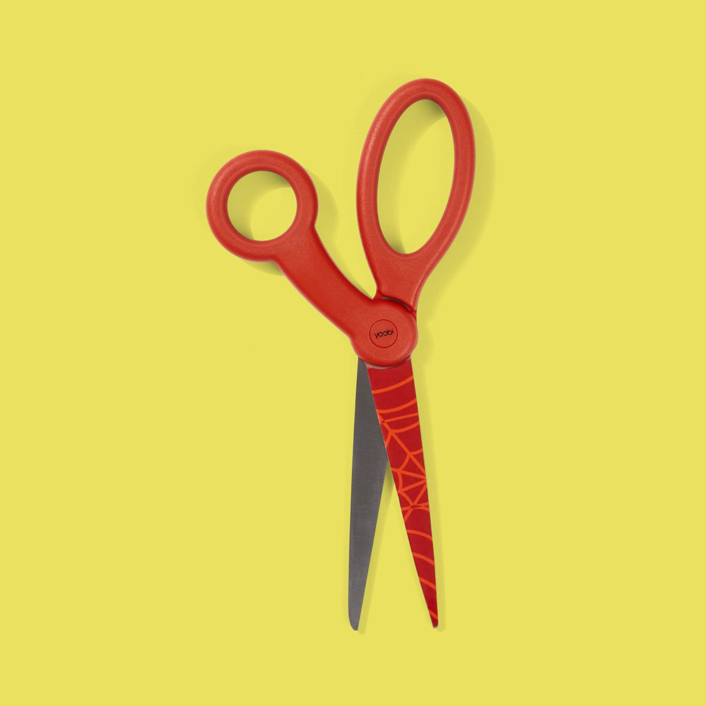 red scissors with red Spider-Man web design on top blade