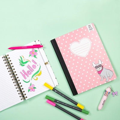 lifestyle image of frenchie polka dot composition book shown with open frenchie spiral journal notebook and markers