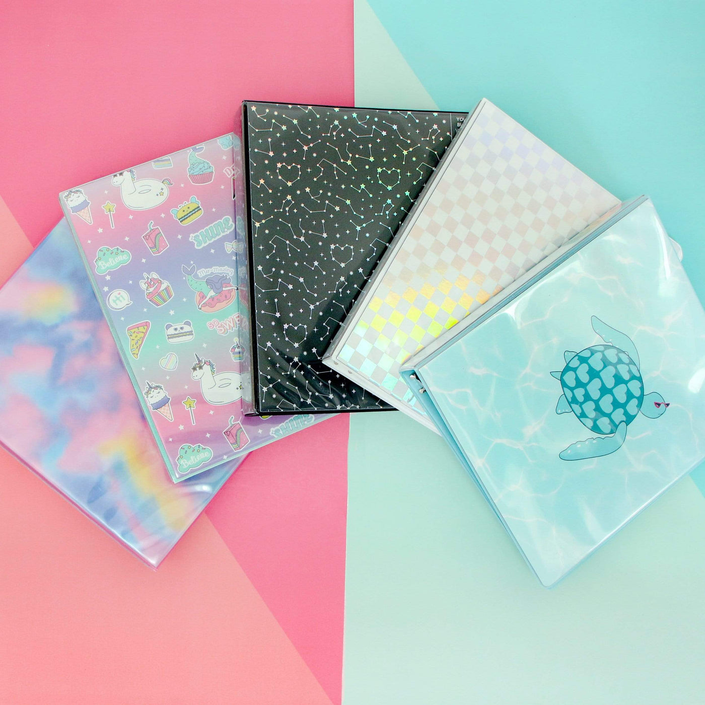 lifestyle image of tie-dye, sweet dreams, constellation, holographic check and aqua turtle binders