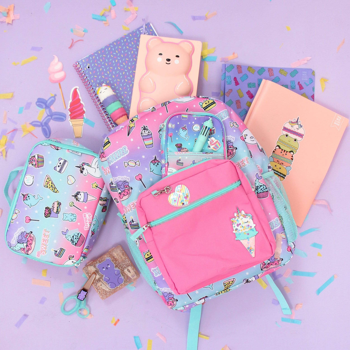 lifestyle image of sweet dreams backpack and lunch bag shown with school supplies in same collection