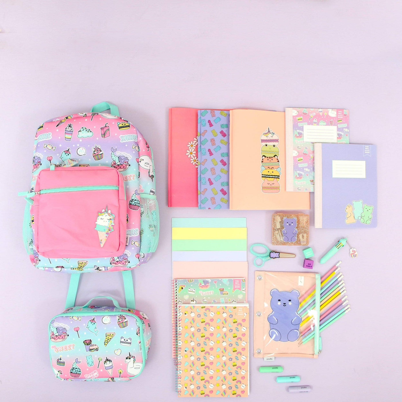 lifestyle image of sweet dreams backpack and lunch bag shown with other schools supplies in same collection