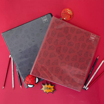 lifestyle image of Avengers black icon binder and red Spider-Man icon binder shown with pencils and sharpener