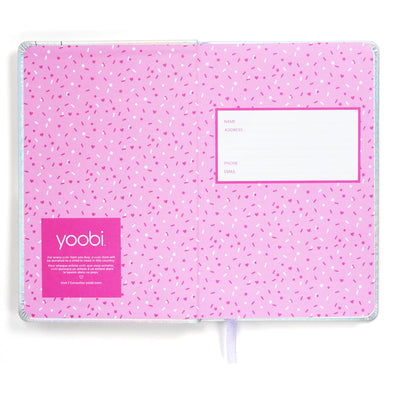 Inside front cover of holographic journal showing pink sprinkles print and contact info label