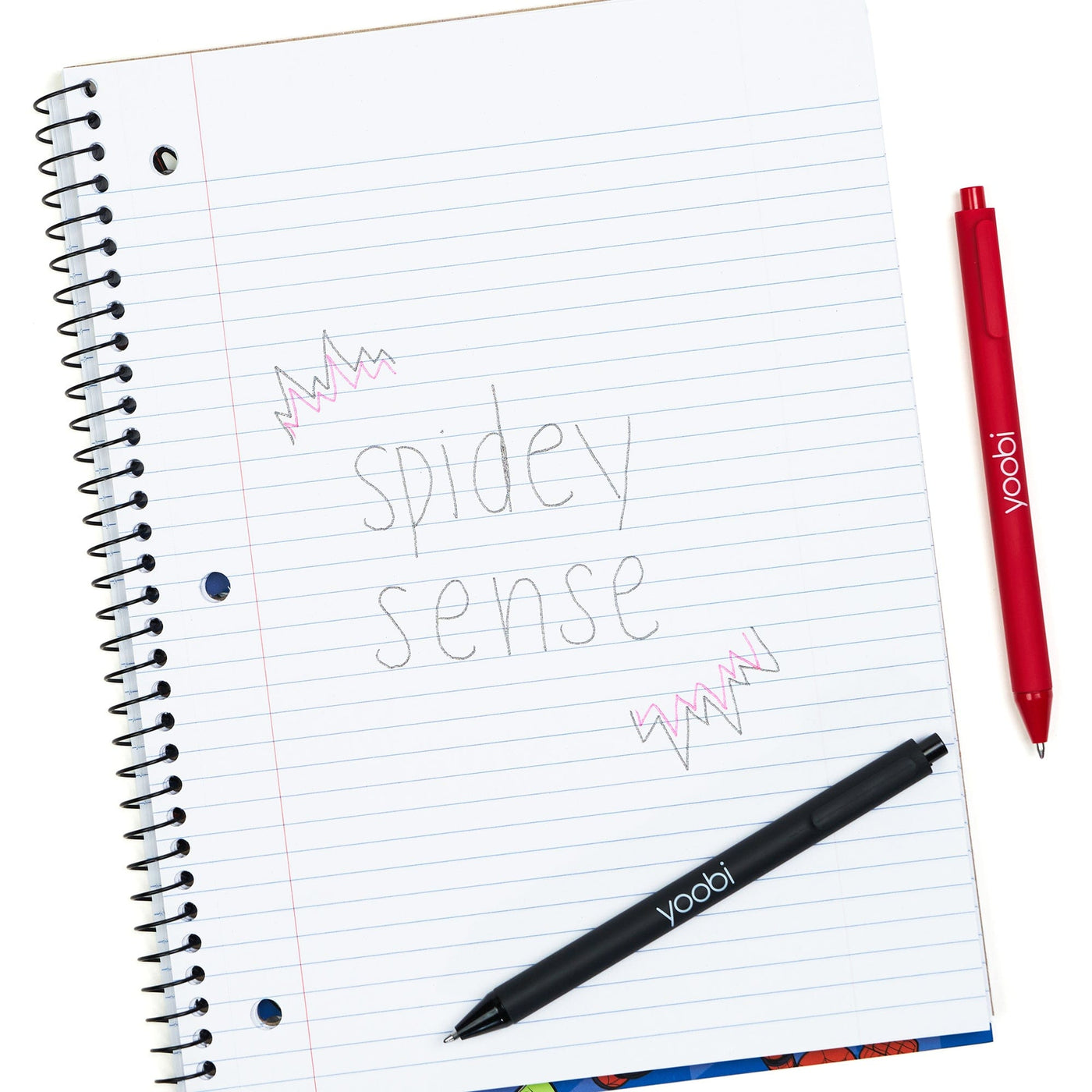 Inside of open one subject spiral notebook showing 3-ring hole punched perforated college ruled paper.  Shown with pens